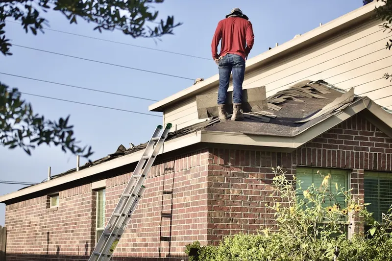 Professional roofer working on a residential roof in Passaic Park